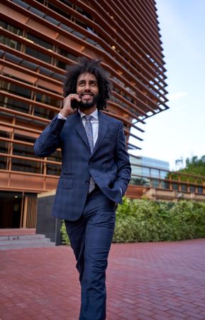 smiling businessman talking on smartphone