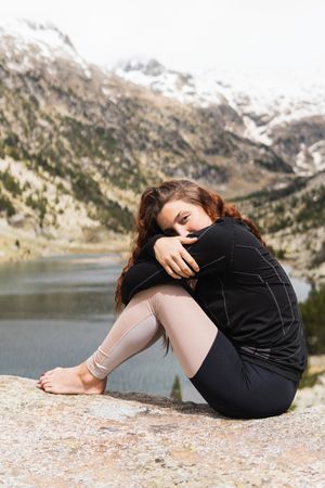 Traveling woman sitting resting in mountains