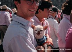 Mexico City, Mexico - February 26th, 2022: Man holding adorable chihuahua at protest in Mexico City 4j9YW5