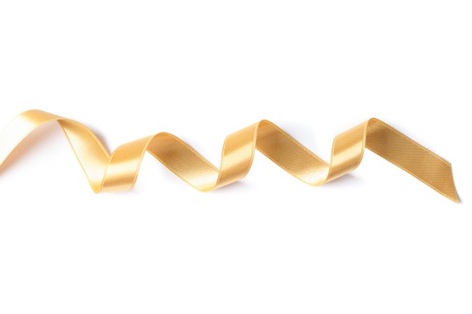 Gold ribbon isolated on plain background. Gift concept