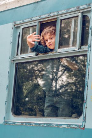 Boy looking out window in train