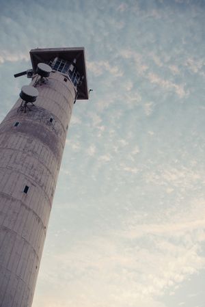 Round grey lighthouse tower rising up to sky