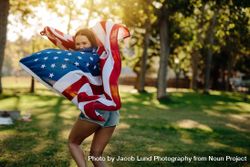 Girl running with USA flag in the park 0ynnL5