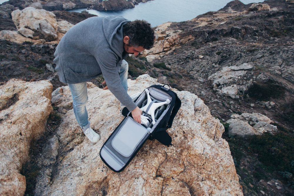 Man with backpack with drone equipment