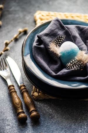 Table setting with pastel egg decor and feathers