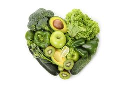 Heart made of vegetables and fruits on blank background