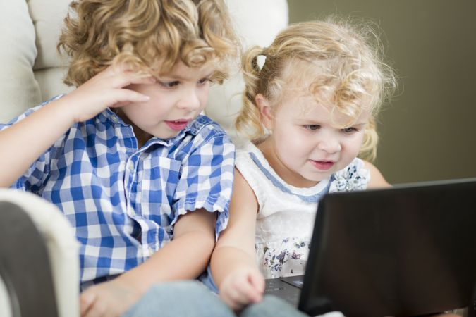 Brother and Sister Using Their Computer Laptop Together