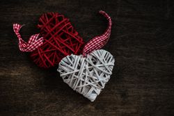 Valentine's day concept of thatched heart decorations on wooden table