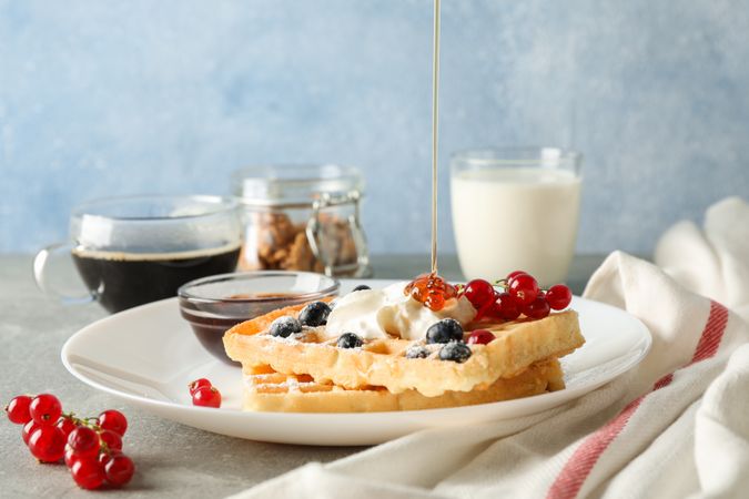 Composition of breakfast with belgian waffles, space for text