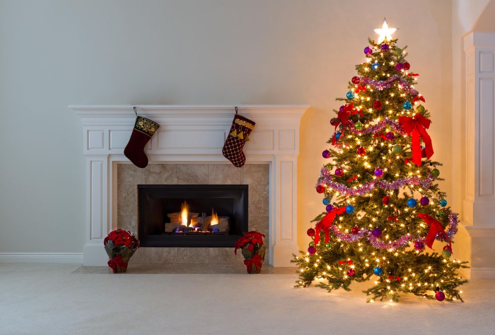 Bright Xmas tree with burning fireplace