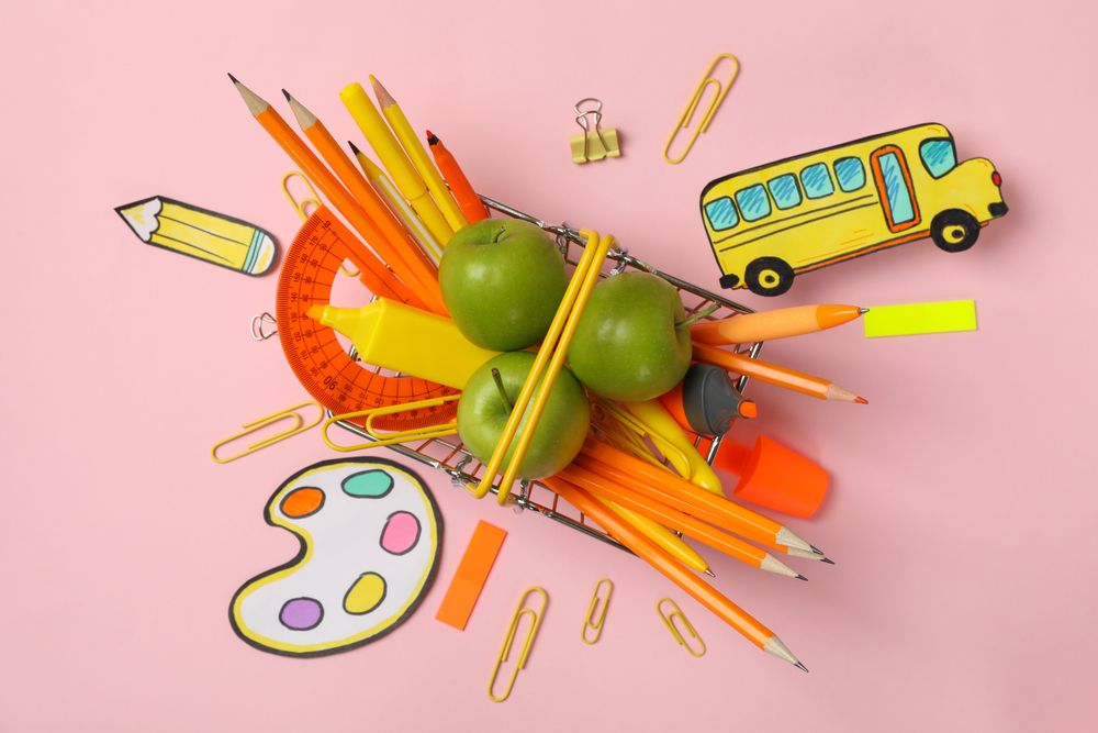 Composition with school supplies on pink background, top view