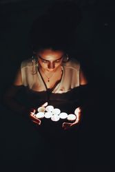 Woman swimming in pool with candles