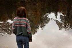 Woman delighting in views near lake and mountains