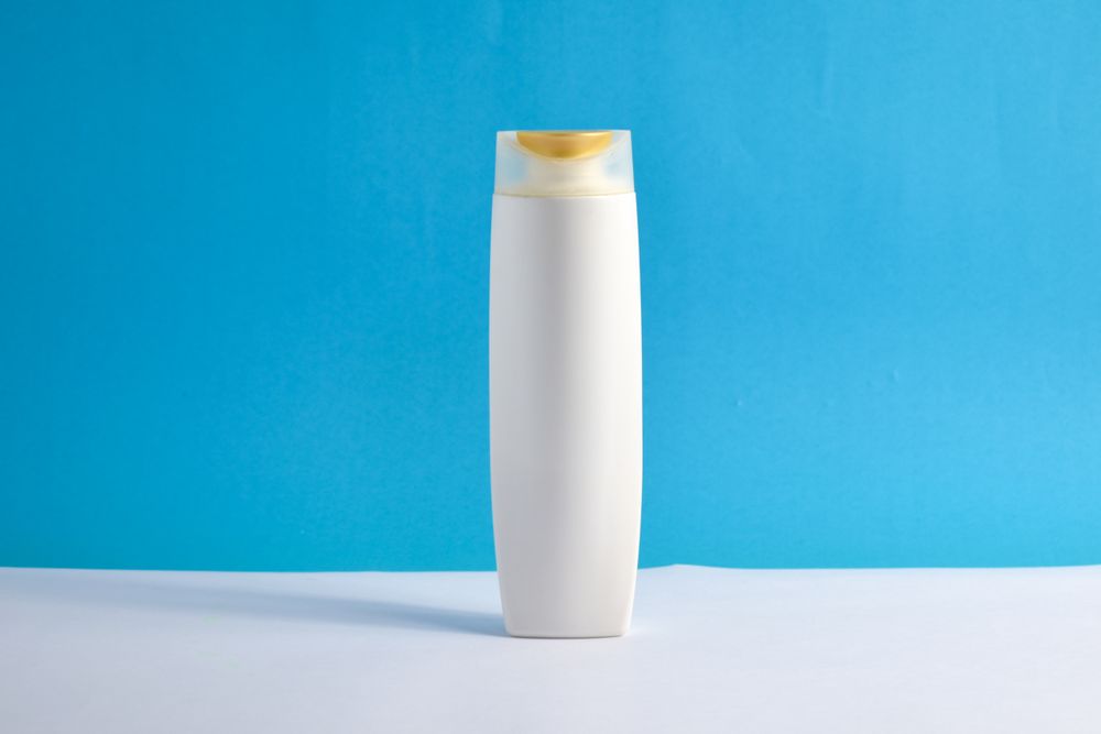 Body wash bottle with no labels in blue room