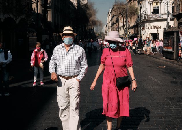 Mexico City, Mexico - February 26th, 2022: Man and woman walking with crowd protesting