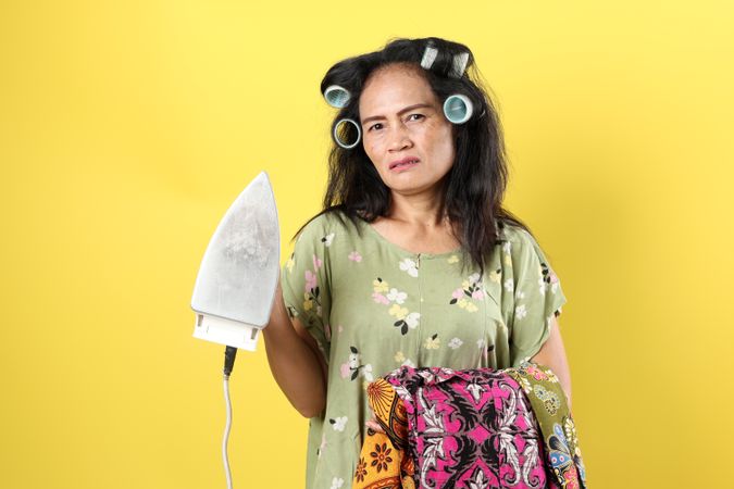 Asian Female Tired Ironing Clothes