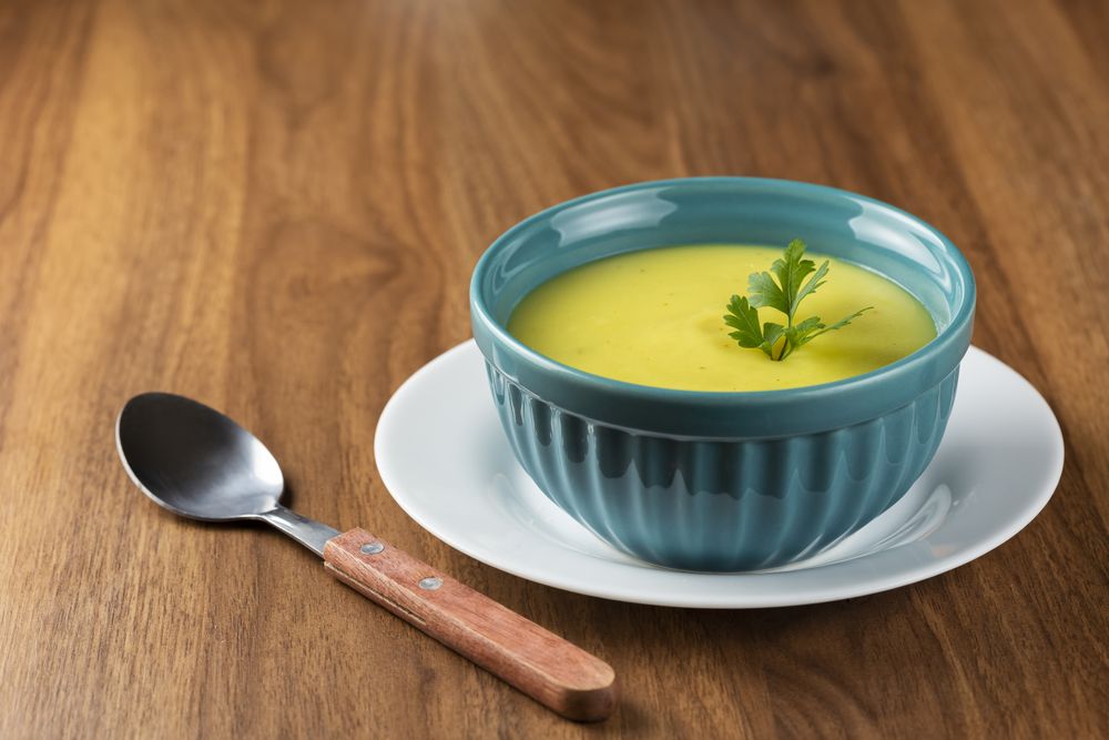 Bowl with onion soup and croutons on the table.