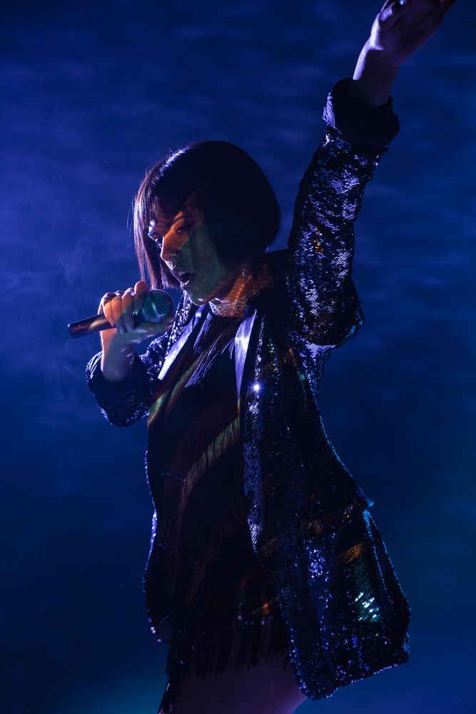 Stylish woman singing on stage