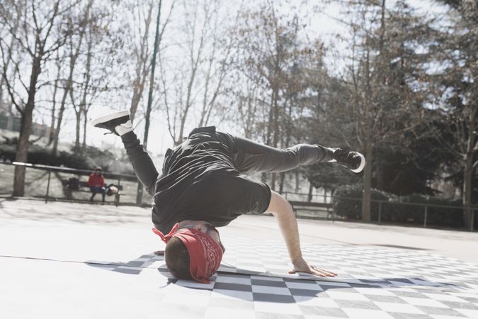 Man dancing break dance in park