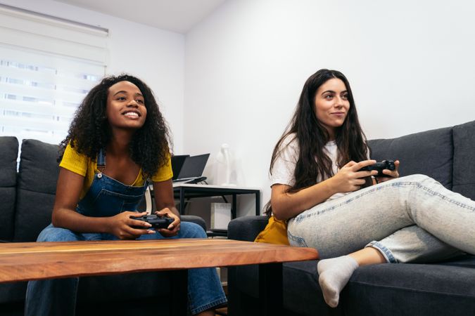Friends bonding over console gaming in living room