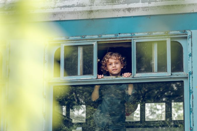 Smiling boy in train near window