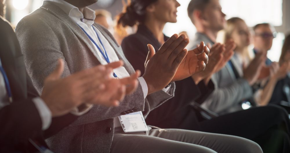 Close Up on Hands of Audience of People Applauding in Concert Hall During Business Forum Presentation. Technology Summit Auditorium Room With Corporate Delegates. Excited Entrepreneurs Clapping.