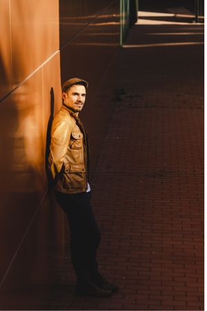 Confident guy leaning on wall