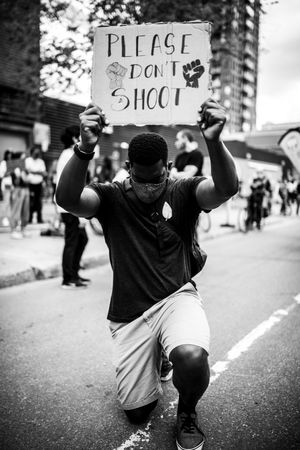 MONTREAL, QUEBEC, CANADA – June 7 2020- Man holding a “please don’t shoot” sign
