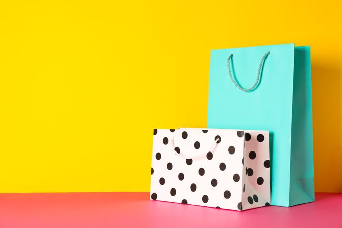 Paper bags on multicolor background, space for text
