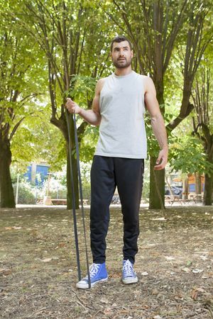 Sportsman stretching arms in park