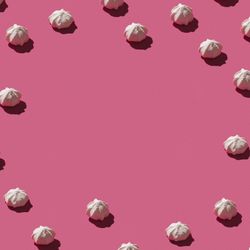 Pattern of meringues on pink background