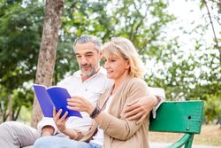 Happy couple spending time together relaxing in a public park