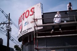 Two men working on an billboard