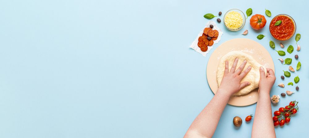 Overhead of a person kneading pizza dough