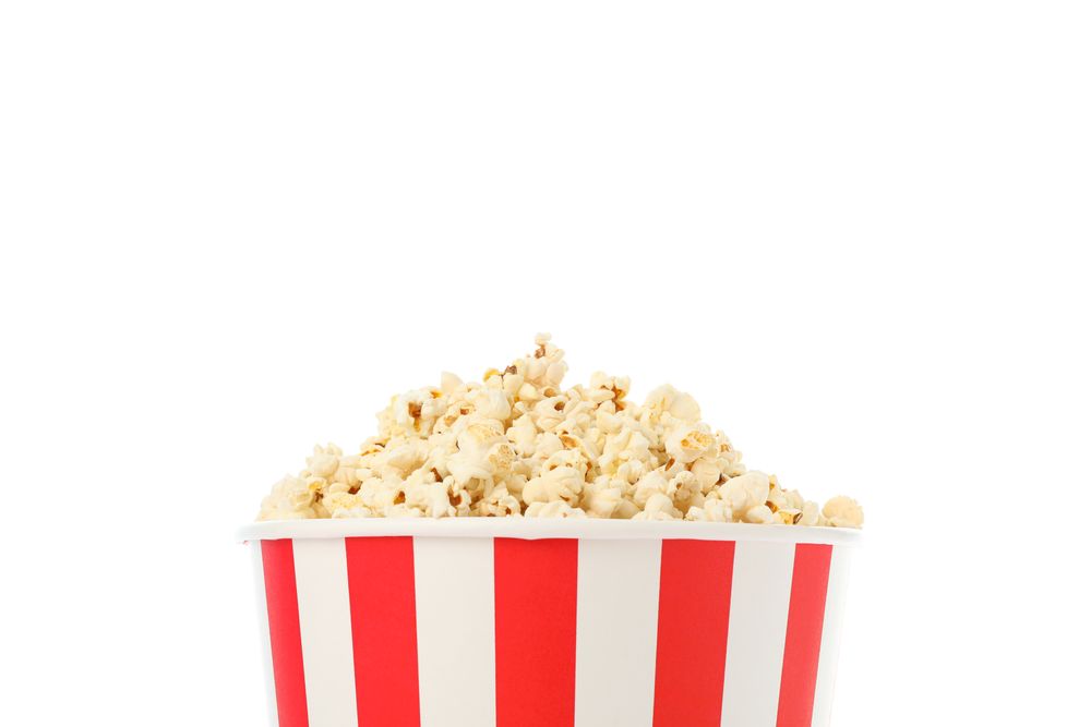Striped bucket with popcorn isolated on blank background