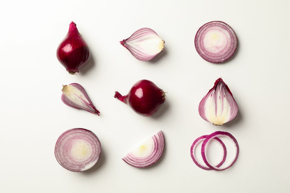 Flat lay composition with red onion on neutral background