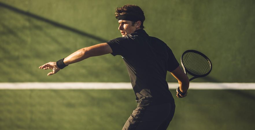 Man playing game on tennis court