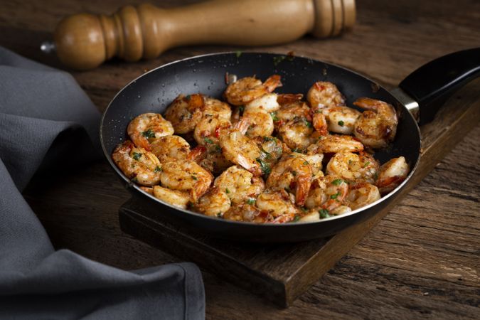 Delicious grilled prawns on wooden background.