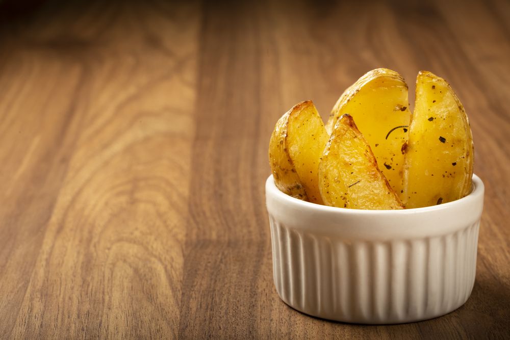 Roasted potatoes with rosemary on the plate.