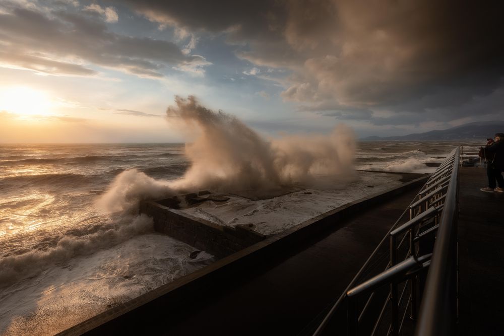 Wave crashing into concrete seashore
