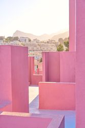 Complex geometric building with pink walls