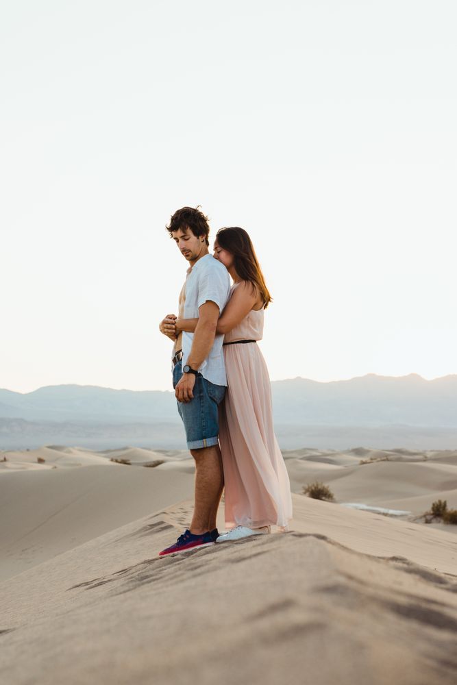 Tender couple hugging in sandy desert valley