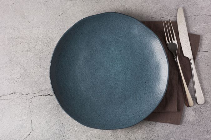 Empty plate on the slate table. Top view of the image.