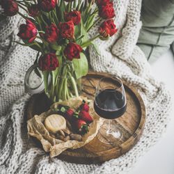 Wine and snacks with flowers square crop