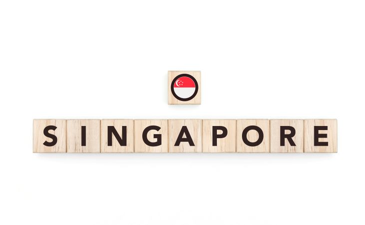 Wooden blocks bearing the name and flag of Singapore. Singaporean and Asian Culture, national identity, travel, and geography in a copy space design.