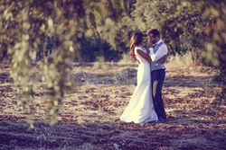 Newlyweds holding each other in nature