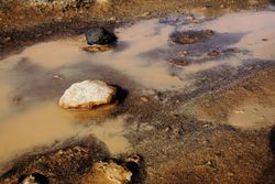Dirty clay water with rocks