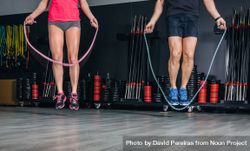 Legs of man and woman jumping rope in fitness class 4d8eAl