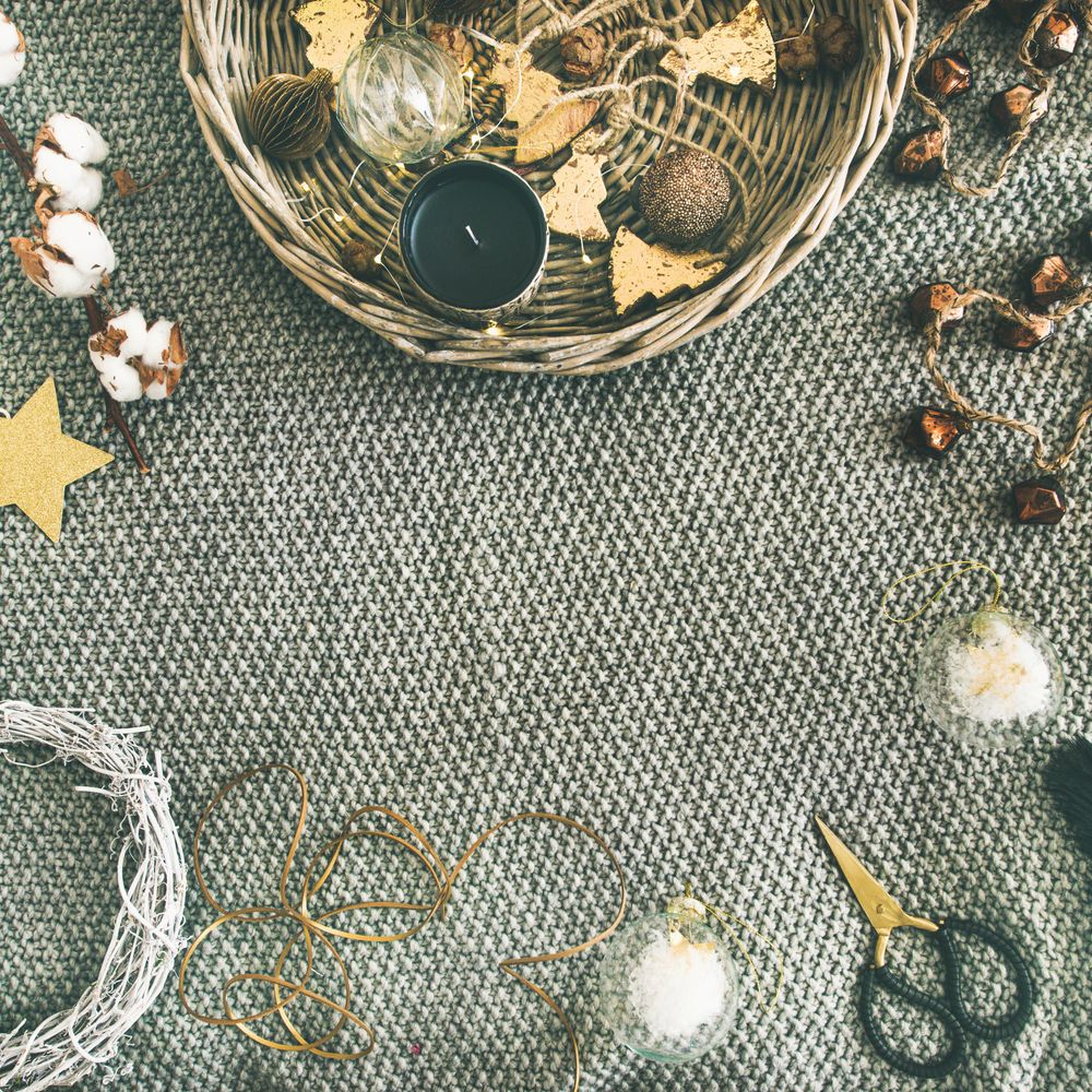 Top view of basket of Christmas decorations on blanket, with copy space