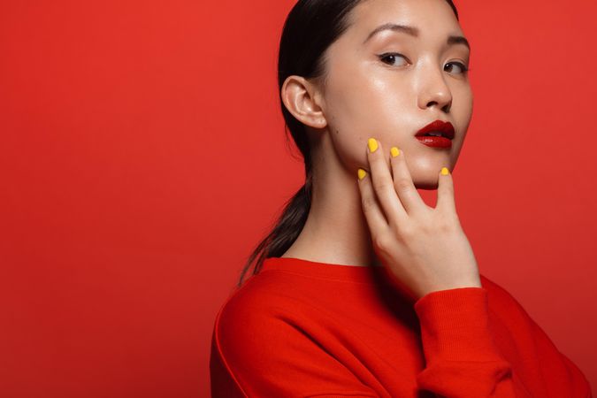 Young female model with red top and lipstick